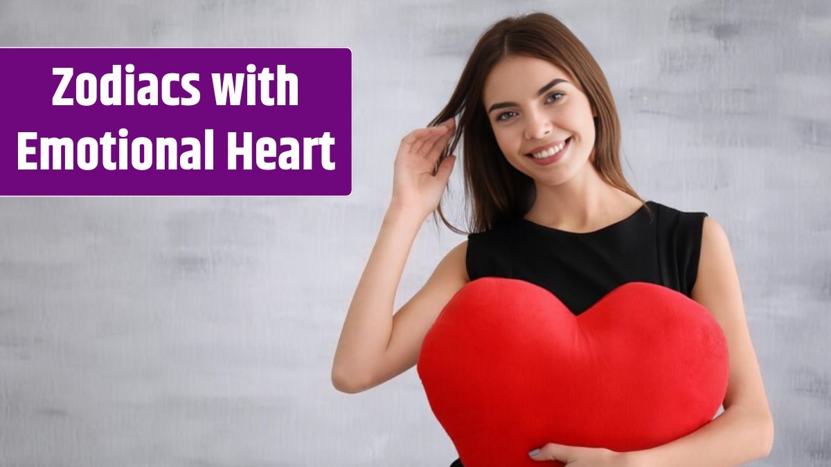 Romantic young woman with heartshaped pillow on light background.