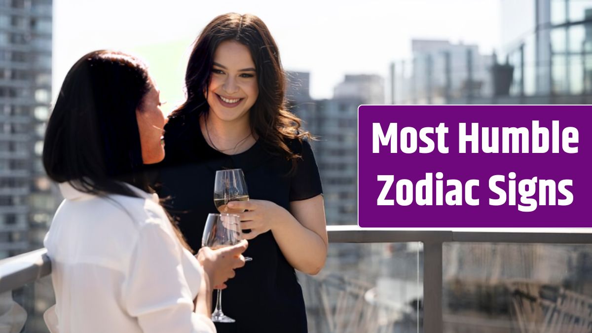 Two female friends spending time together and drinking wine on a rooftop terrace.